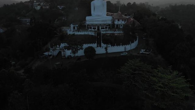a revealing drone shot of a big buddha statue in kandy sri lanka