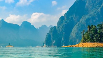 Scenic landscape view of nature island clear water and mountains background at “Cheow Lan Dam (Ratchaprapa Dam)” Suratthani Thailand.