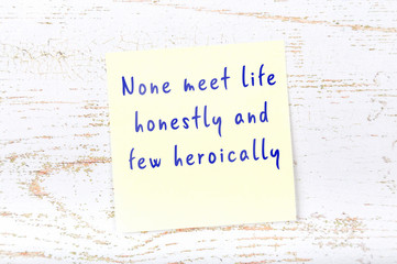 Yellow sticky note with handwritten motivational quote