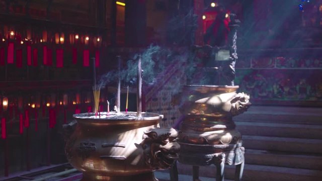 Incense sticks gently smoke inside Man Mo temple, Hong Kong, slow motion