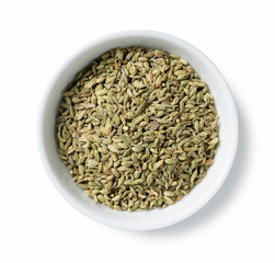 Fennel seeds in a plate placed on a white background