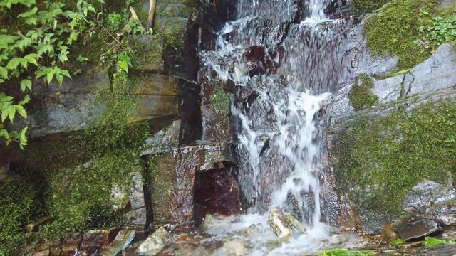 Small cascading waterfall flowing downhill in Longji Rice Terraces, China