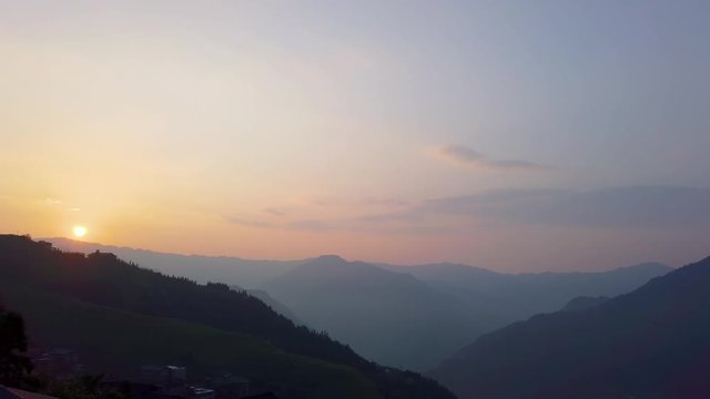 Sunset over Seven Stars Accompany the Moon cascading layered Rice Terraces forming part of Longji Rice Terraces, Pingan village, northern Guilin, Guangxi Province, China