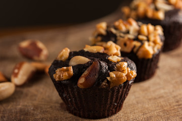chocolate cupcakes with castanha-do-pará and nuts  over a wood plate