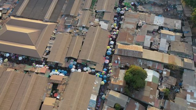 2020 - aerial over West African street market in Gambia passes for Guinea, Bissau, Sierra Leone, Nigeria, Ivory Coast or Liberia.
