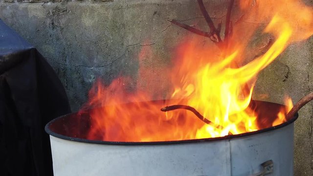 Slow Motion shot of the top section of a fire burning garden waste.