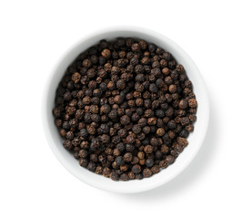 Black pepper in a plate placed on a white background