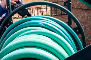 Selective focus on front edge of wound garden hose