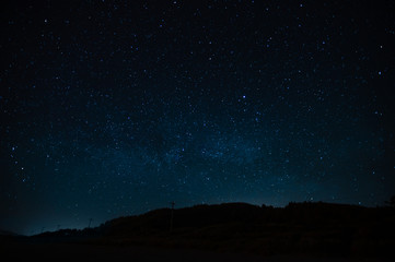 Fototapeta na wymiar Starry sky on a background of a slope, night landscape. Astrology, horoscopes, astro screensaver, space