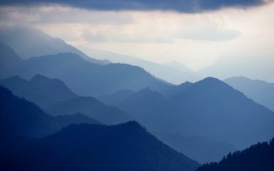 blue mountain range against back light at Chiemgau alps, Germany