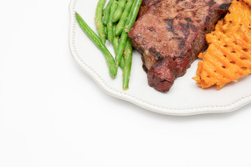 Steak dinner with green beans and sweet potatoes
