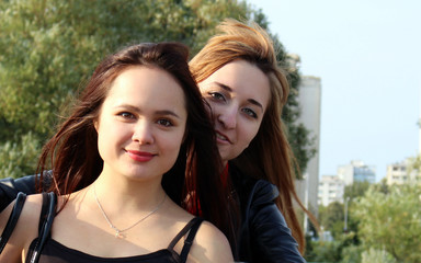 Two young girls walking near the bridge.