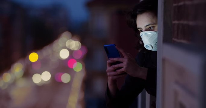 Quarantine self-isolation. Coronavirus in the USA and Europe. A person holding a cell phone. Girl chatting online with friends. Portrait of masked people during quarantine