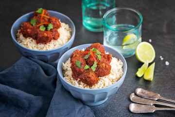 Meatballs in tomato sauce on rice 