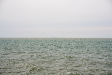 Waterfront view with water and cloudy sky