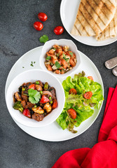 Mexican chicken stew with fresh tomato salsa and flat bread tortilla 