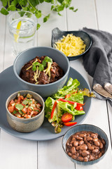 Mexican beef stew with fresh tomato salsa and flat bread tortilla 