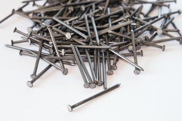 Pile of nails on white isolated background