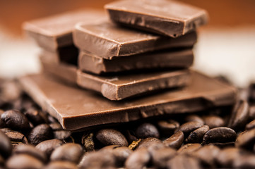 Pile of coffee beans with chocolate on burlap cloth background