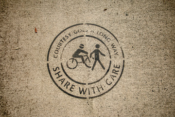 Share with care sign for cyclists and pedestrians. Message to be tolerant and cooperate