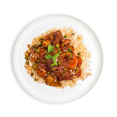 A bowl of Chicken and vegetable stew in tomato sauce served on rice on dark wooden background