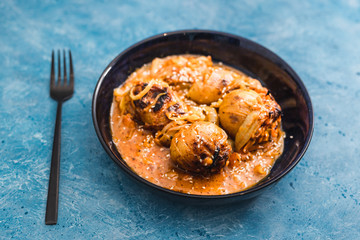 plant-based food, baked potatoes with creamy vegan onion and carrot sauce