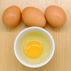 Close-up view of raw chicken eggs on background