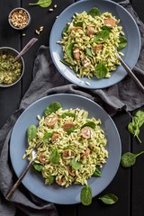 A bowl of Orzo pasta salad with chorizo sausage, spinach and pesto dressing