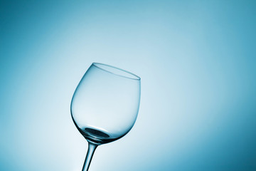 empty wine glass blue background