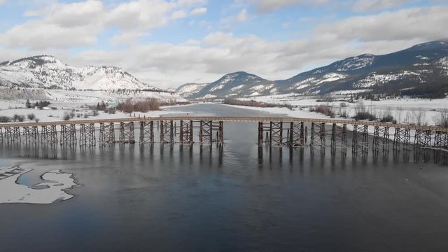 Drone view of Pritchard Wooden Bridge in British Columbia in the winter time with car crossing