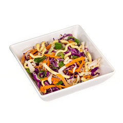 Plate of Mixed red and white cabbage slaw salad with crispy asian noodles  isolated on white 