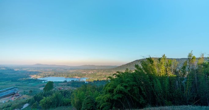 High view Time lapse Landscape Sunrise with mountain, hill with trees, blue sky with mist.