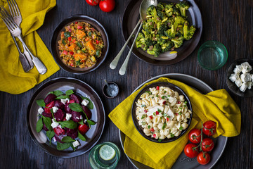 Salad Bar with Bowls of various salads  on wooden table 
