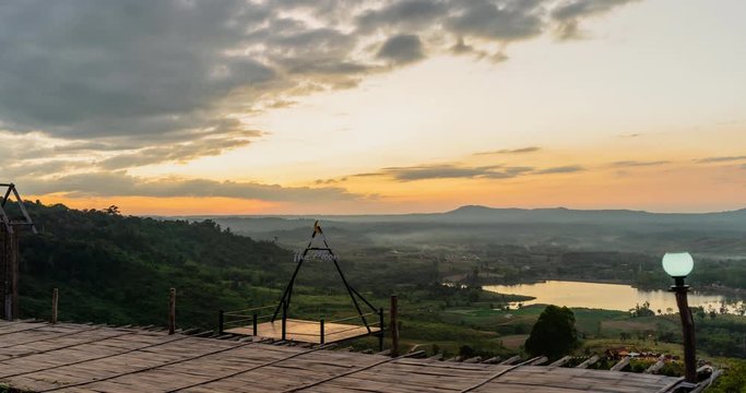 High view Time lapse Landscape Sunset with mountain, hill with trees, blue sky with mist.
