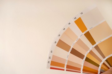  sample colors catalogue on a beige background. palette of building paints in beige and brown...