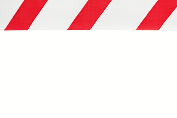One red and white warning tape on an isolated white background, the feed is located on top. Concept for protecting people from coronavirus infection. Coronavirus, Covid-19