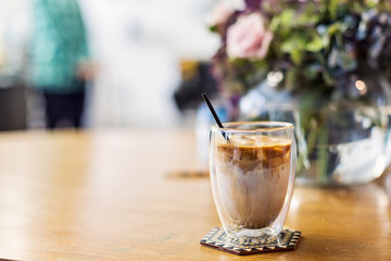 Glass of iced coffee on a cafe table  with copy space 
