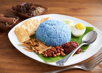Nasi lemak, a traditional malay curry paste rice dish served on a banana leaf
