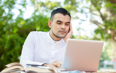 Wear a protective mask to prevent disease,young asian business man, work from home,In the back of the house to be happy