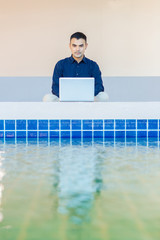 young asia business man, Happy young man working on laptop,at his working from home,Mock up copy space,Beside the pool