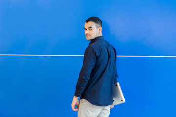 young asian business man, Happy young man working on laptop,at his working from home,Mock up copy space,On a blue background