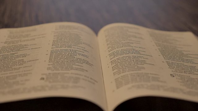 Holy Bible Falling Open in Slow Motion