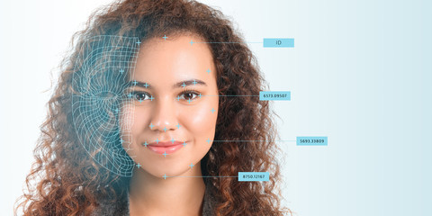 Young businesswoman using facial recognition system for data protection