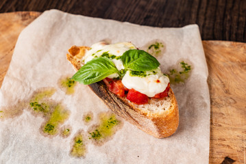 Traditional italian bruschetta with cherry tomatoes, cream cheese, basil leaves