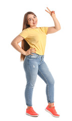 Portrait of beautiful young woman showing victory gesture on white background
