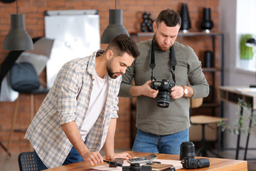 Mentor teaching young photographer in studio