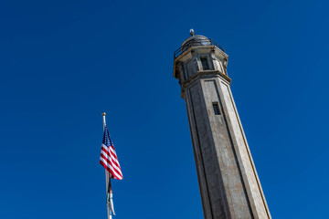 Lighthouse and the USA Flag from the Alcatraz Island Prison in San francisco USA. Federal prison...