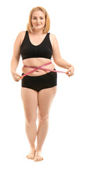 Overweight woman with measuring tape on white background. Weight loss concept