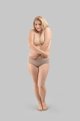 Naklejka premium Sad overweight woman on grey background