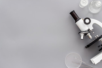 Research with microscope. Laboratory backround with blood sample on grey table top view copy space